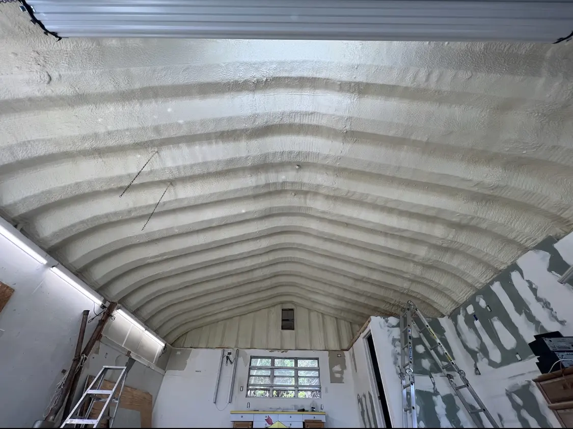 Spray polyurethane foam applied to the underside of a metal roof deck in Lower Salford